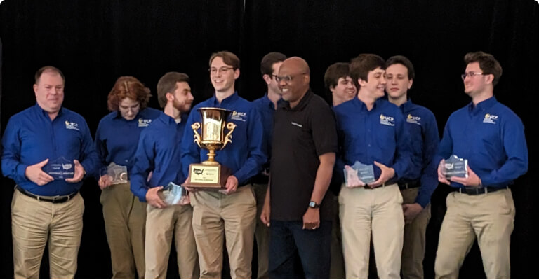 men with blue shirts on stage